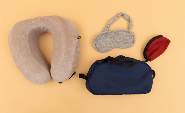 A Navy Parapack Grab Bag with travel sleep accessories next to it including a Small Mars Red Q-Kit.